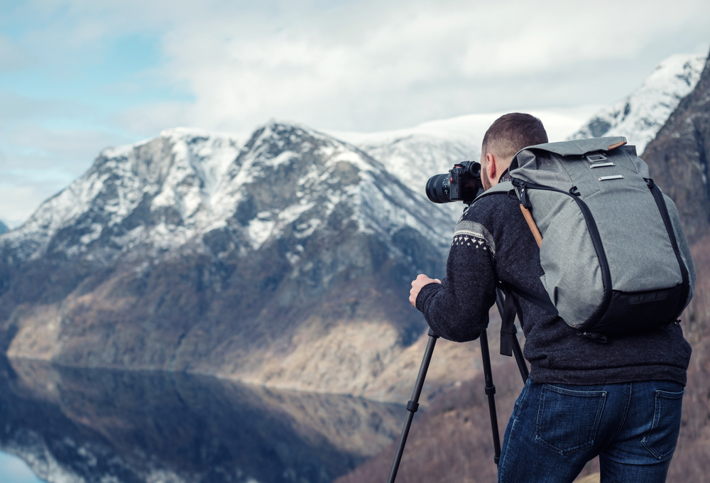A person with a camera on a mountain

Description automatically generated with low confidence
